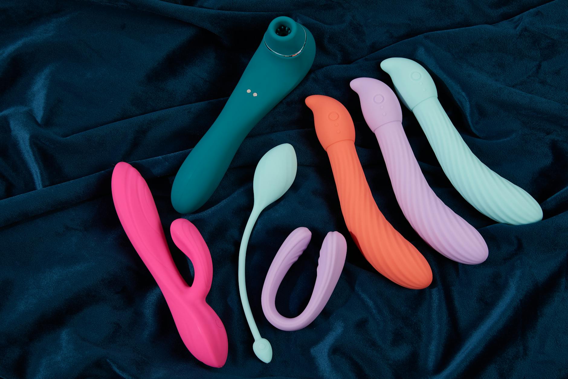 Woman holding pink and blue vibrators, reconnecting with sensual pleasure